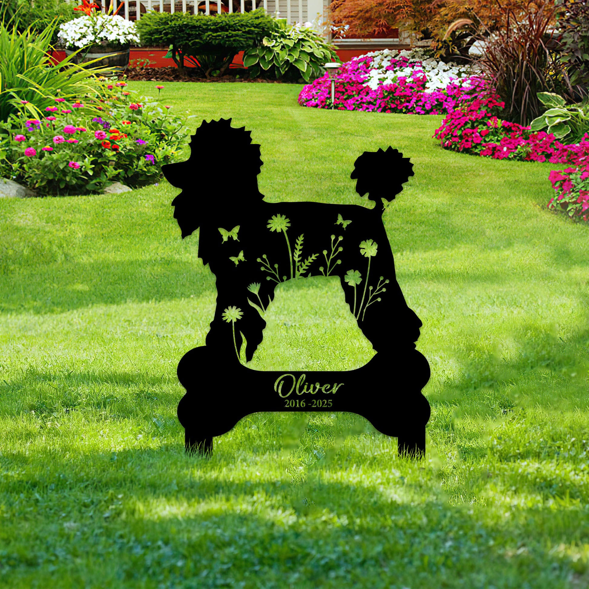 Poodle memorial garden sign with floral cutout details shown among colorful flowers and green lawn