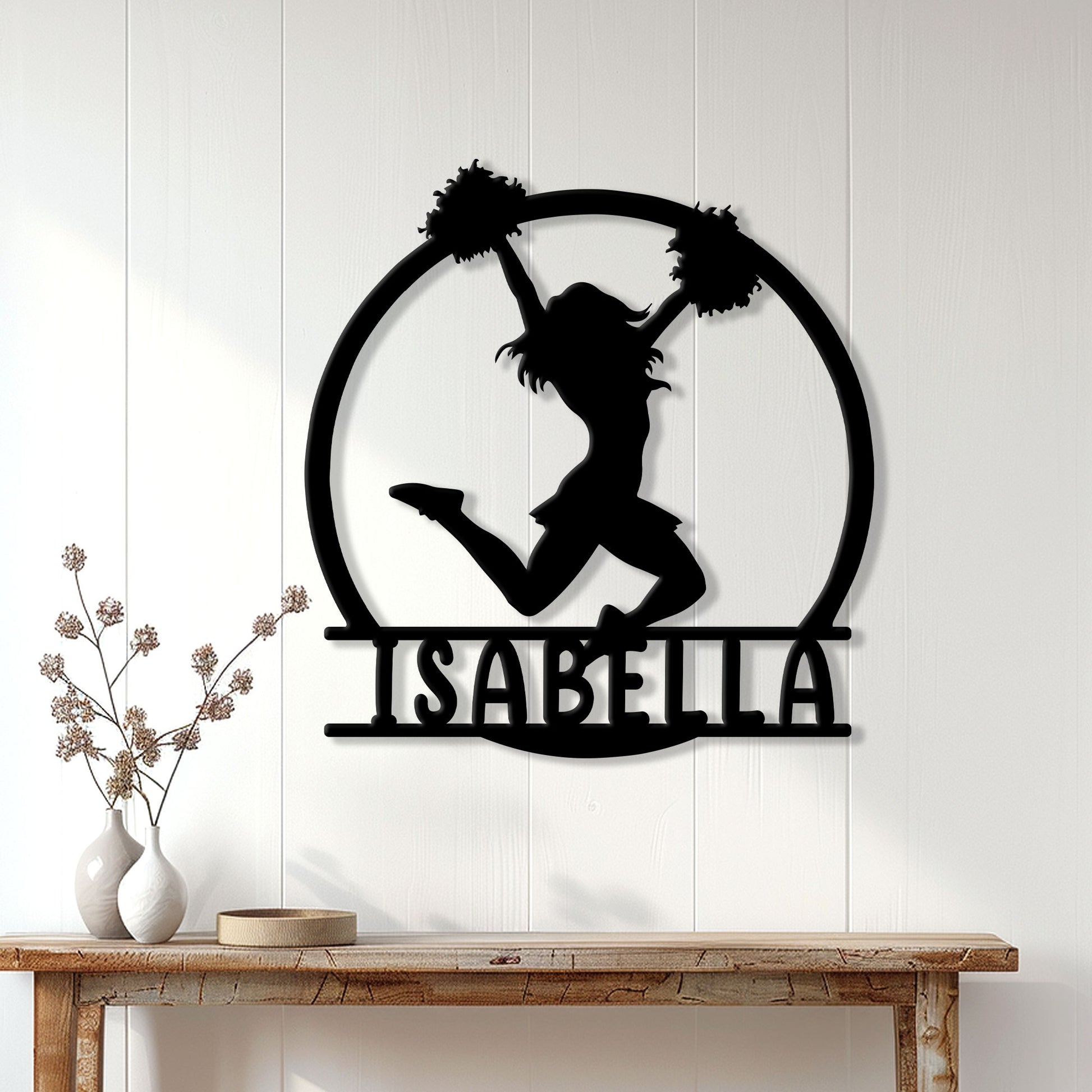 Cheerleader silhouette metal wall sign displayed on a light wood wall above a console table