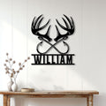 Hunting wall decor displayed above a console table, featuring black deer antlers and crossed arrows