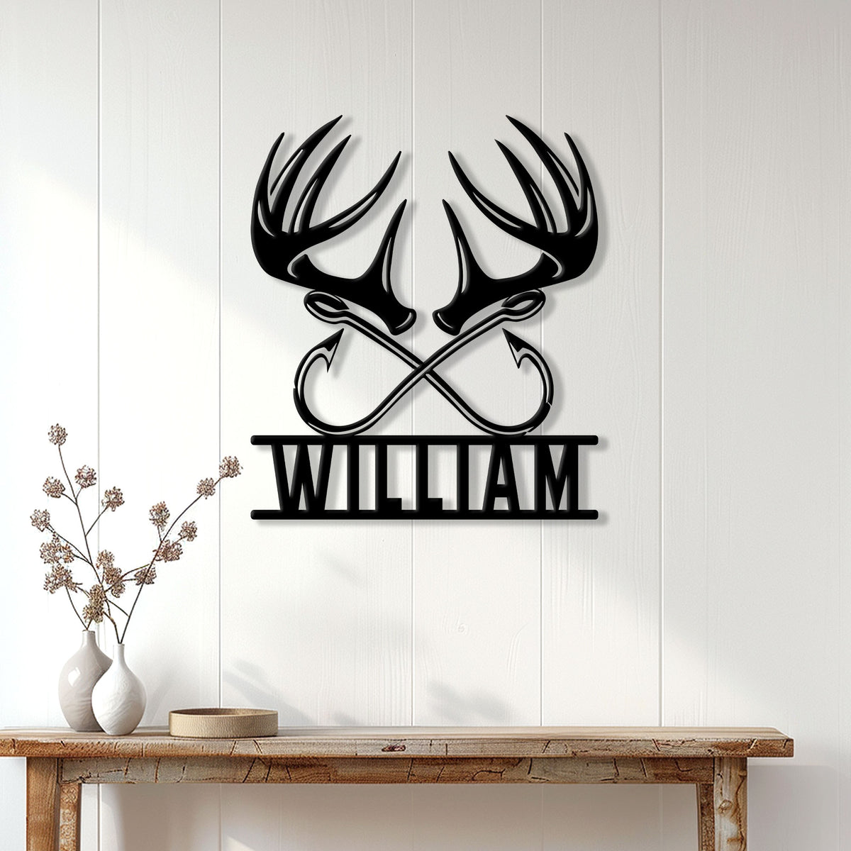 Hunting wall decor displayed above a console table, featuring black deer antlers and crossed arrows