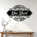 She Shed metal sign displayed on a white paneled wall above a wooden console table