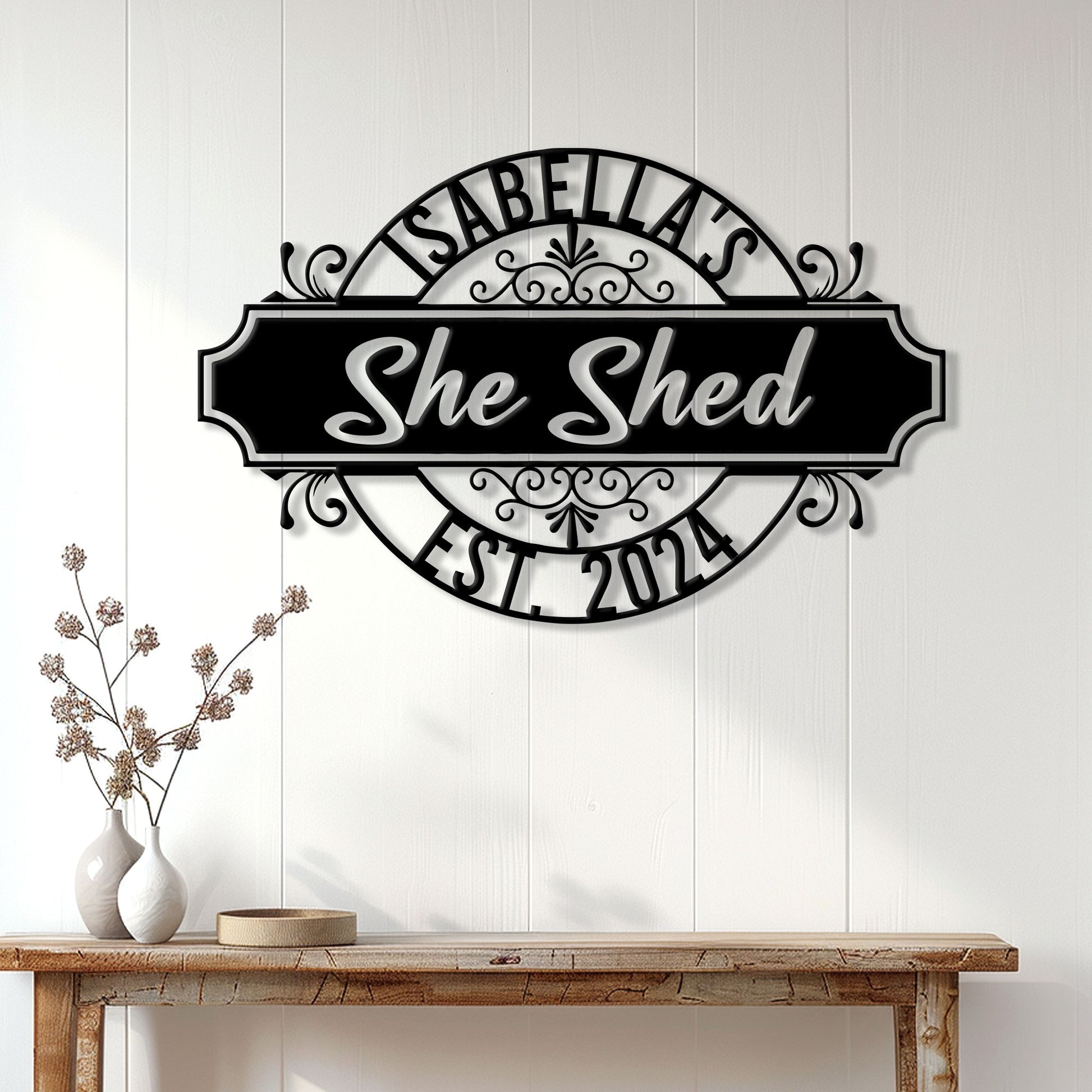 She Shed metal sign displayed on a white paneled wall above a wooden console table