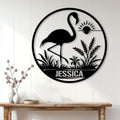 Black flamingo silhouette wall sign displayed above a console table in a bright modern entryway