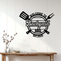 Backyard BBQ metal sign displayed on a white paneled wall above a rustic console table