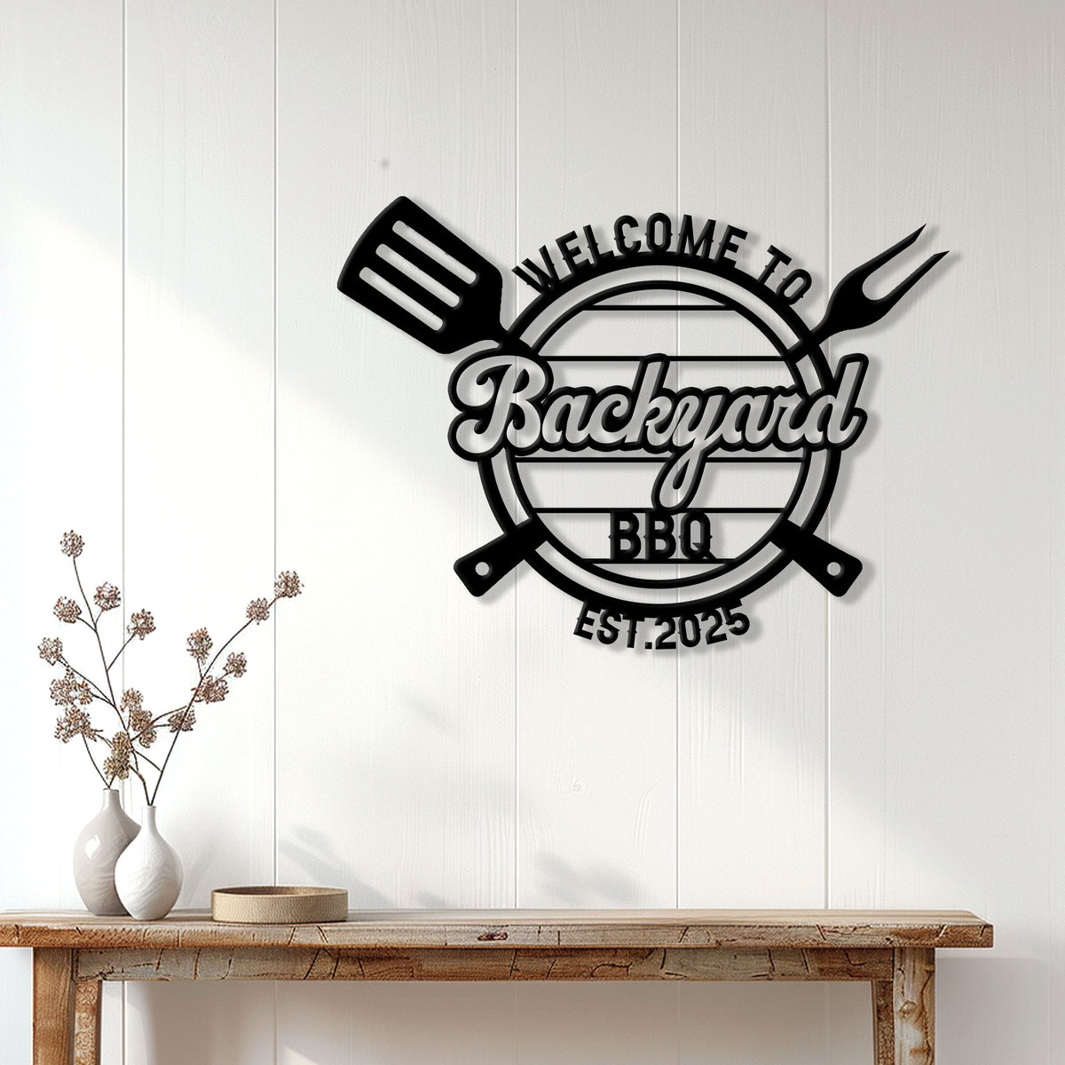 Backyard BBQ metal sign displayed on a white paneled wall above a rustic console table