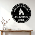 Custom BBQ metal sign displayed on a white paneled wall above a rustic console table