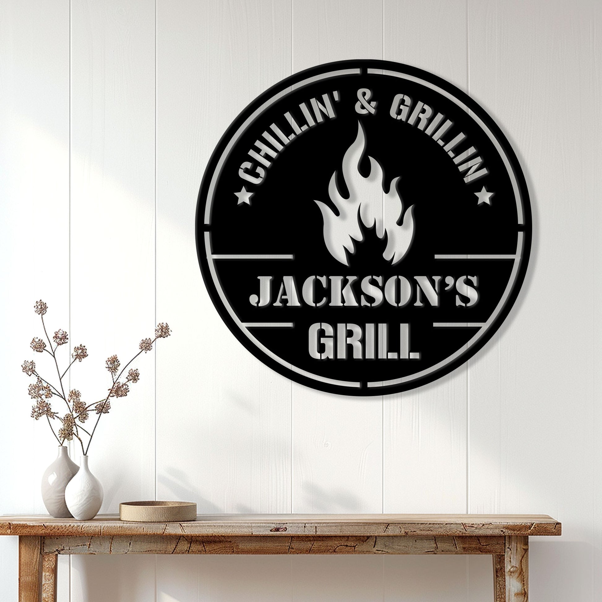 Custom BBQ metal sign displayed on a white paneled wall above a rustic console table