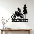 Motocross metal wall sign displayed on a light paneled wall above a rustic console table