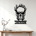 Flaming skull metal wall sign displayed on a white paneled wall above a wooden console
