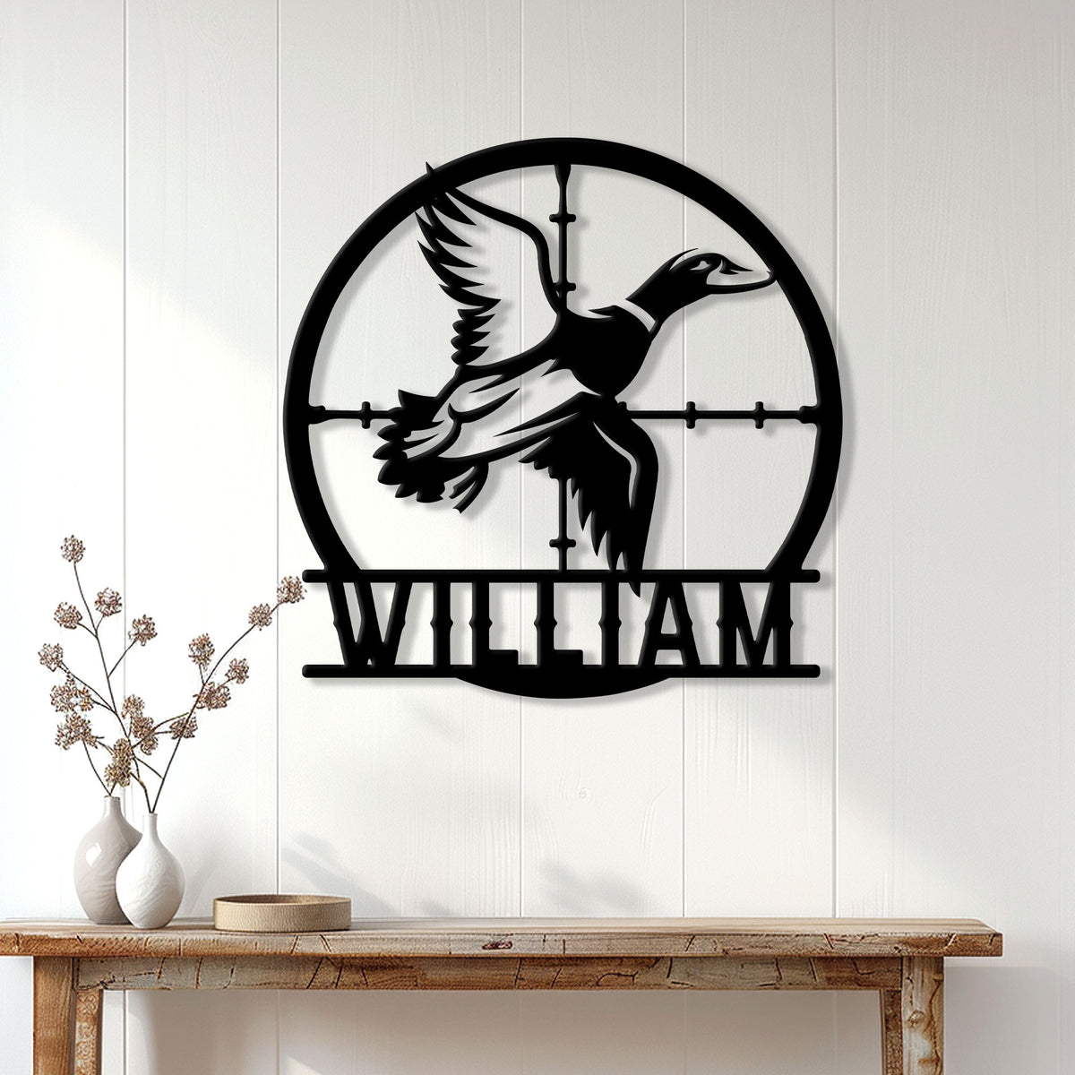 Duck hunter wall decor displayed on a white paneled wall above a rustic console table