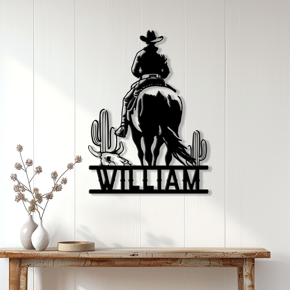 Western cowboy metal wall sign displayed above a rustic console table in a bright home entryway
