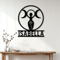 Custom triple moon goddess metal sign displayed on a light wood-paneled wall above a console table