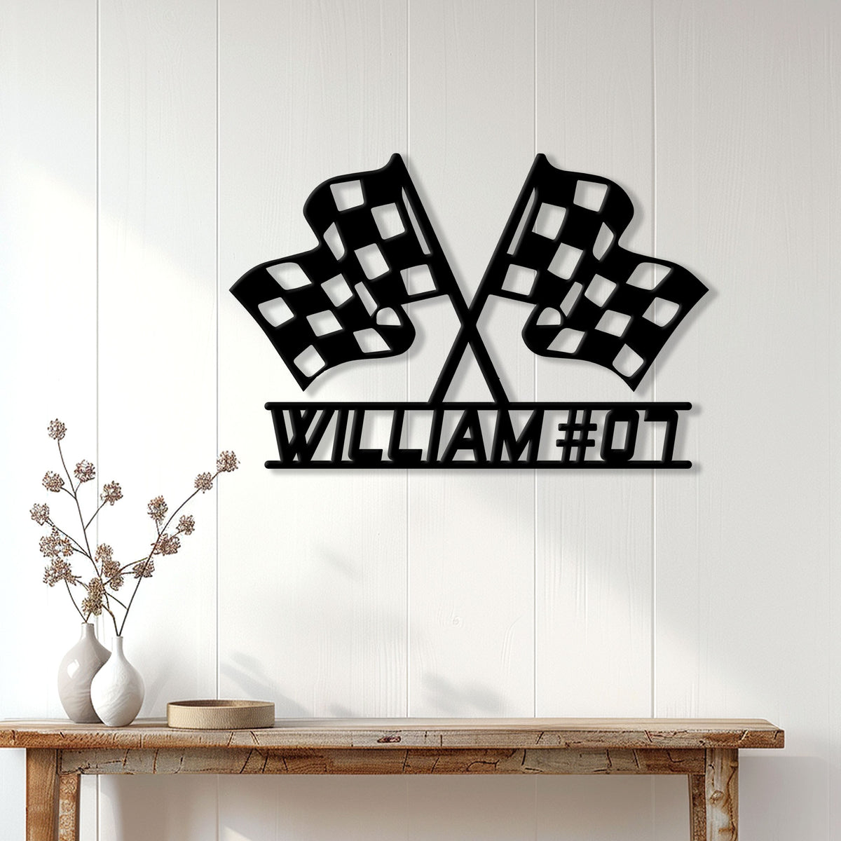 Crossed checkered flag racing sign displayed on a light paneled wall above a console table
