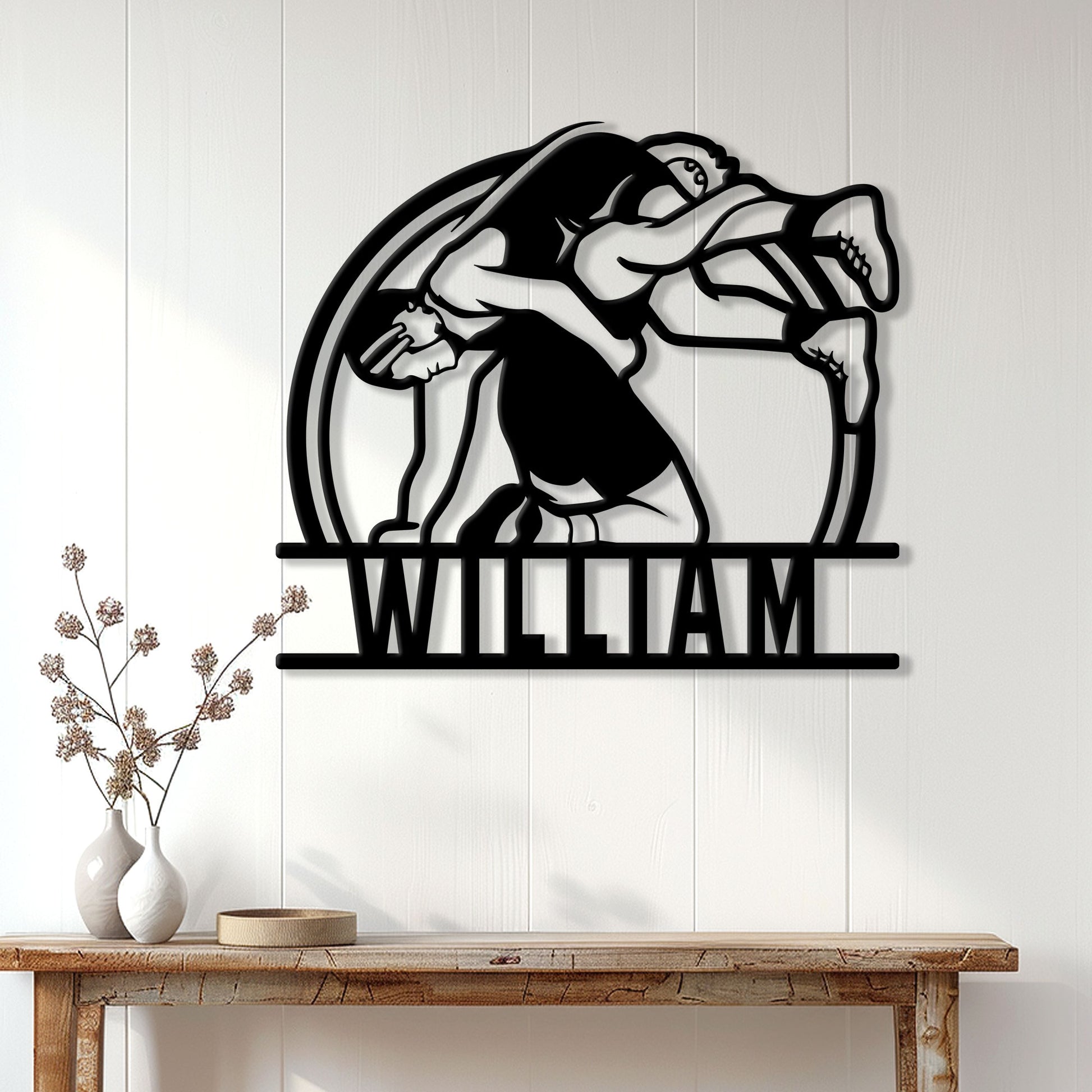 Wrestling wall decor displayed above a console table, featuring a bold silhouette of two grapplers