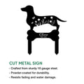 Black cut metal dachshund memorial sign featuring a floral silhouette and bone-shaped base