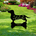 Dachshund memorial garden sign displayed among flowers and green lawn landscaping