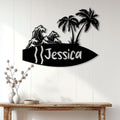 Custom surfing metal sign displayed on a light wood-paneled wall above a console table