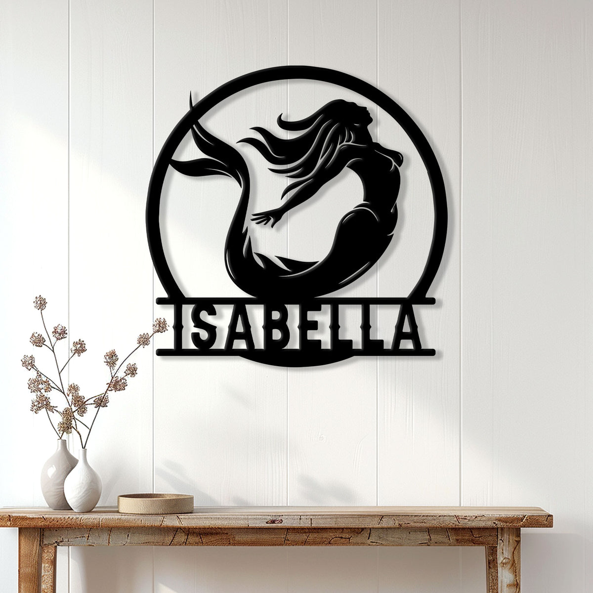 Mermaid wall sign displayed above a console table in a bright, modern home
