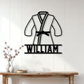 Brazilian jiu jitsu metal sign displayed on a white paneled wall above a console table