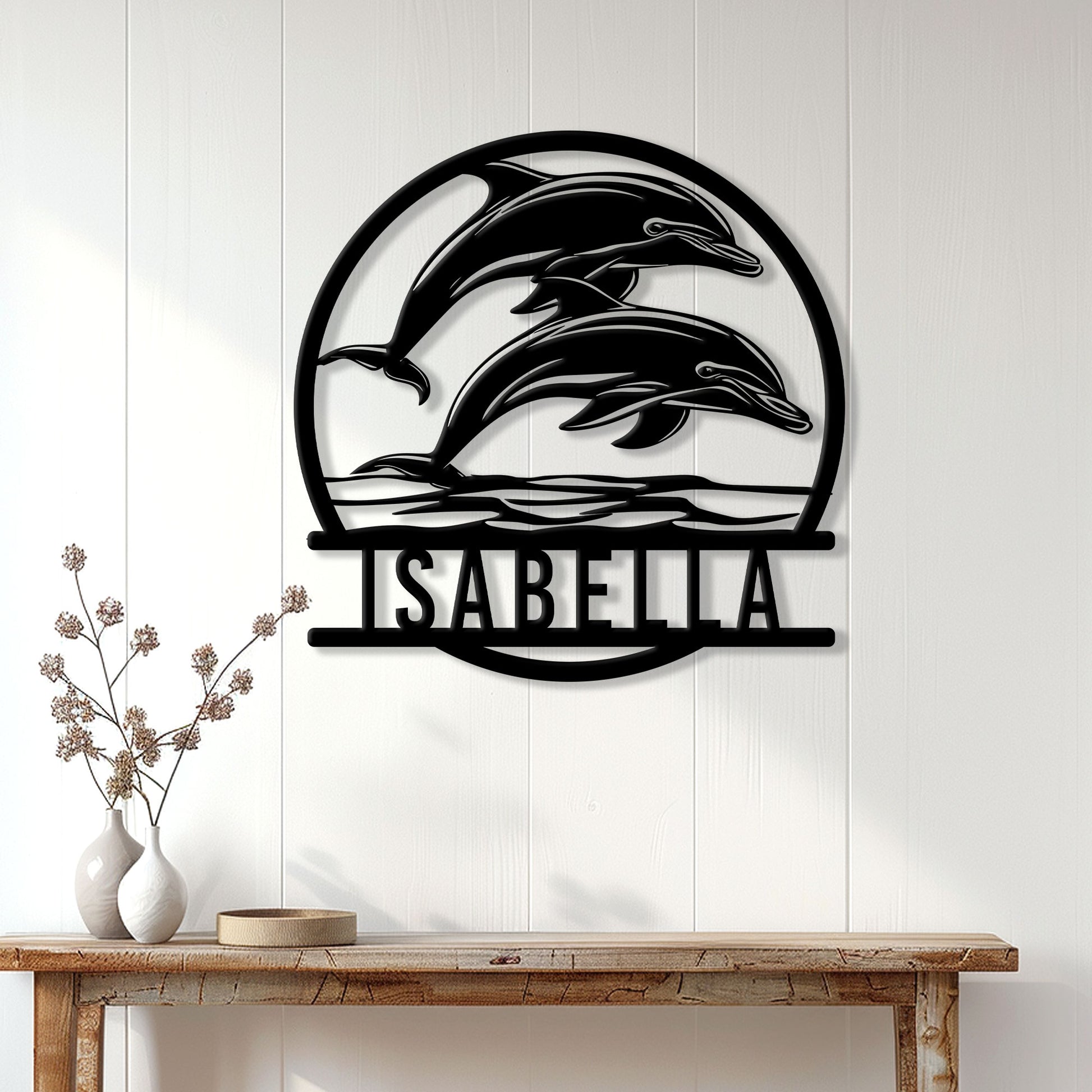 Black dolphin metal sign displayed on a white paneled wall above a console table