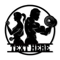 Custom gym metal sign featuring athletic silhouettes lifting weights inside a bold circular design
