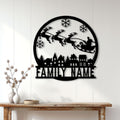 Christmas family metal sign displayed on a white wood wall above a console table