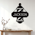 Barber pole metal sign displayed on a light paneled wall above a wood console table