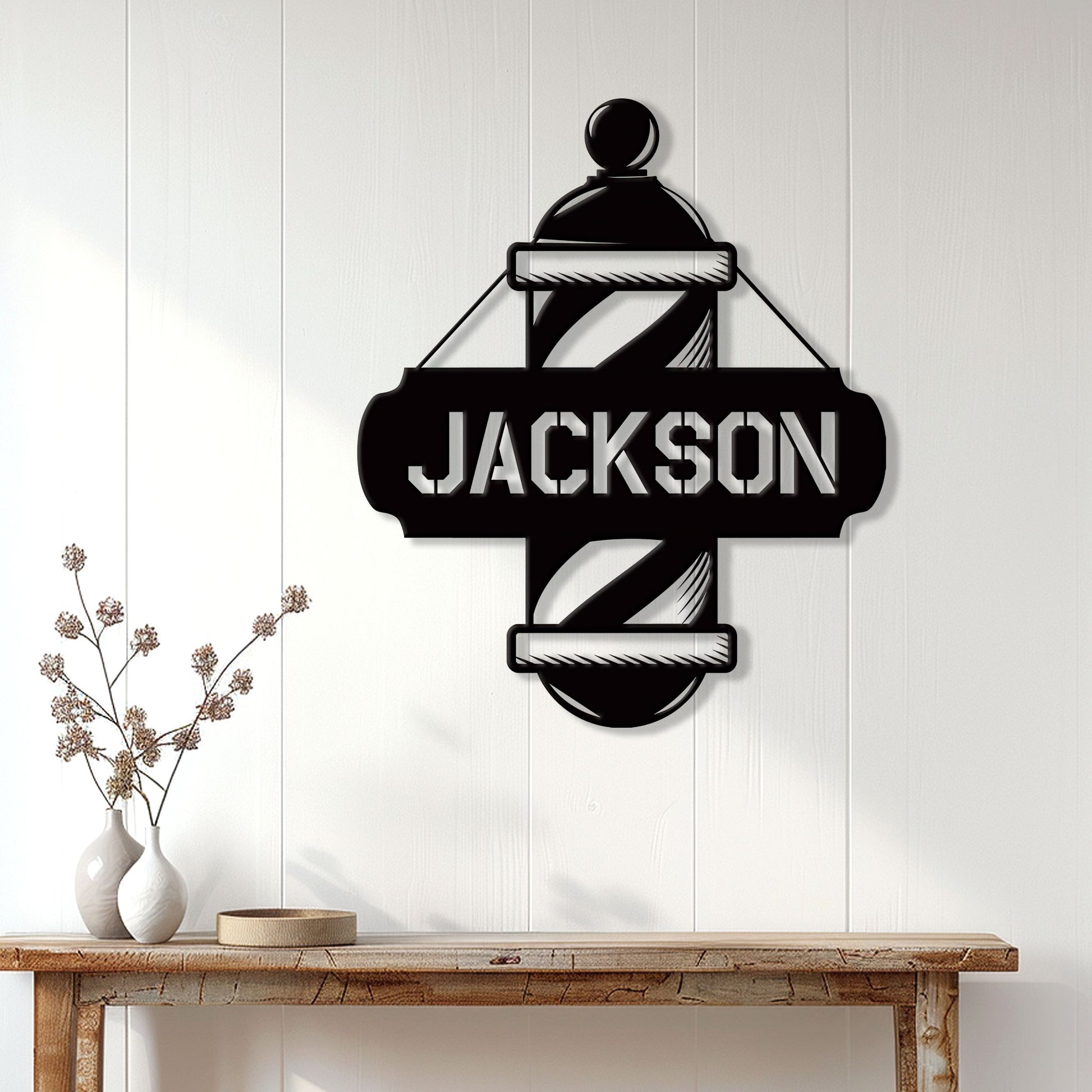 Barber pole metal sign displayed on a light paneled wall above a wood console table