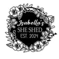 Floral She Shed metal sign with a botanical wreath and bold custom center design