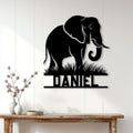 Black elephant metal sign displayed on a light paneled wall above a rustic console table