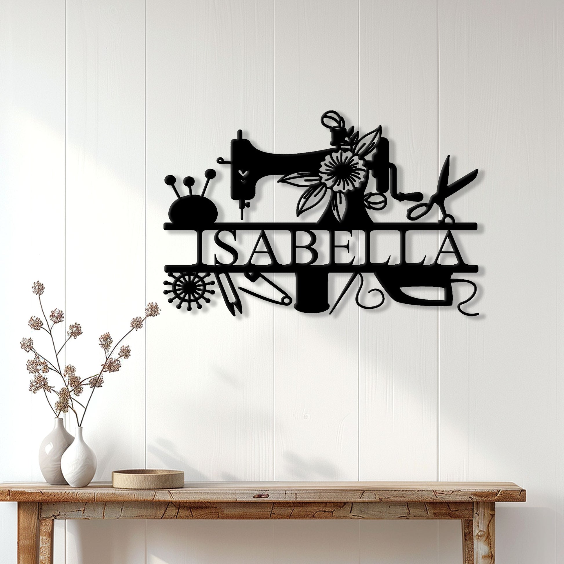 Sewing wall decor displayed above a console table, featuring a sewing machine and floral craft tools