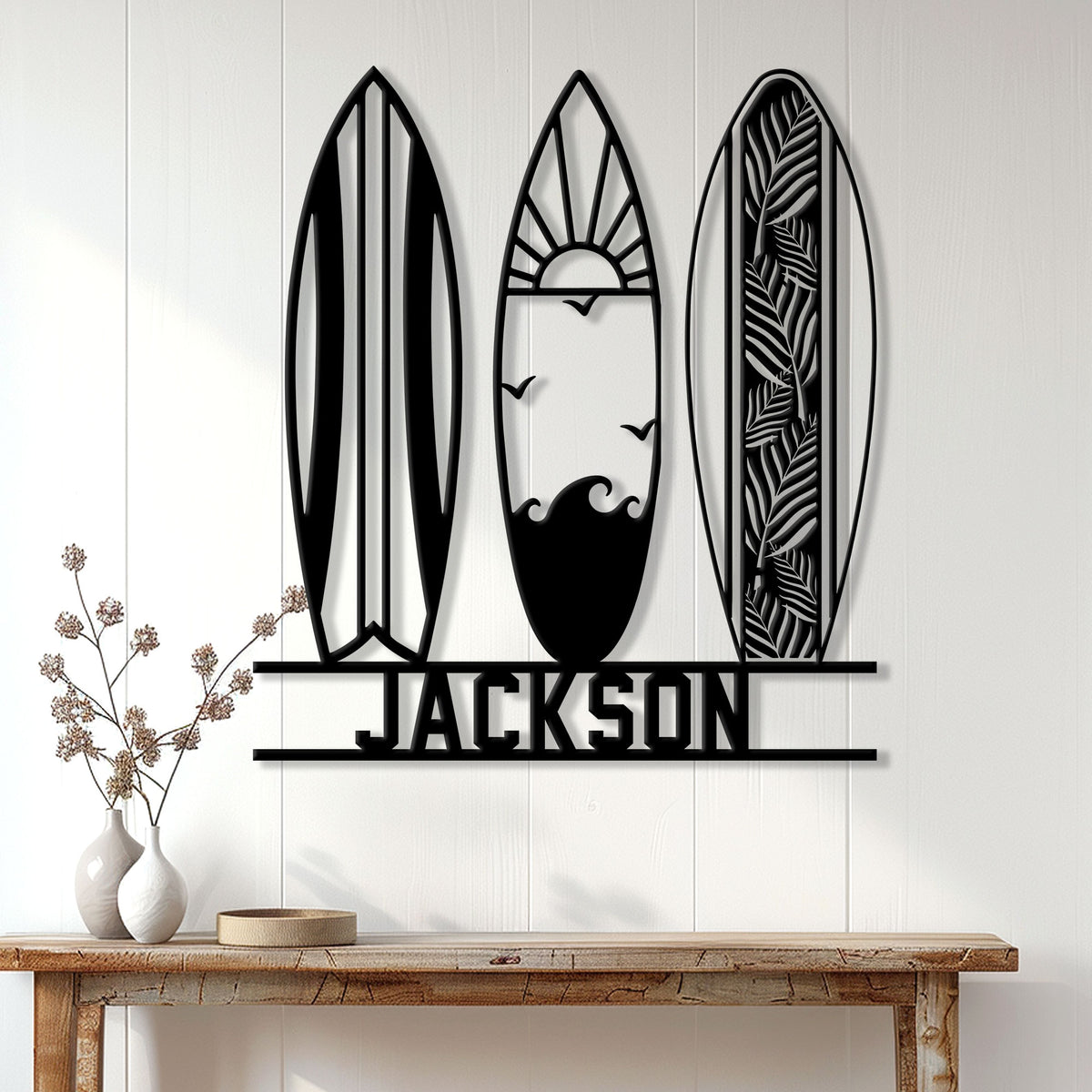 Surfing metal sign displayed on a light wood wall above a console table in a coastal home setting