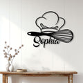 Chef and whisk metal wall sign displayed on white kitchen-style paneling above a rustic console table