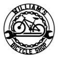 Circular bicycle shop metal sign featuring a road bike, bicycle chain border, and crossed wrenches