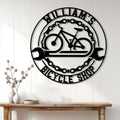 Bicycle shop wall sign displayed above a console table in a bright home interior