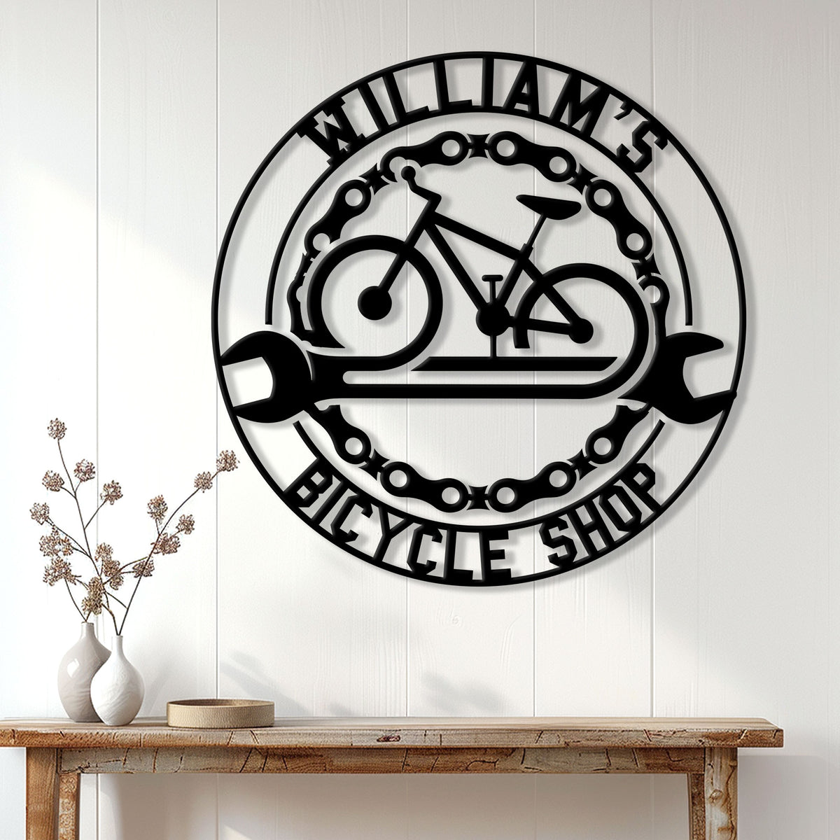 Bicycle shop wall sign displayed above a console table in a bright home interior