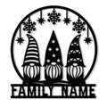 Christmas gnome metal sign featuring three festive gnomes, snowflakes, hanging stars, and a round frame