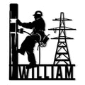 Black silhouette lineman metal sign showing a worker climbing a utility pole beside a power transmission tower
