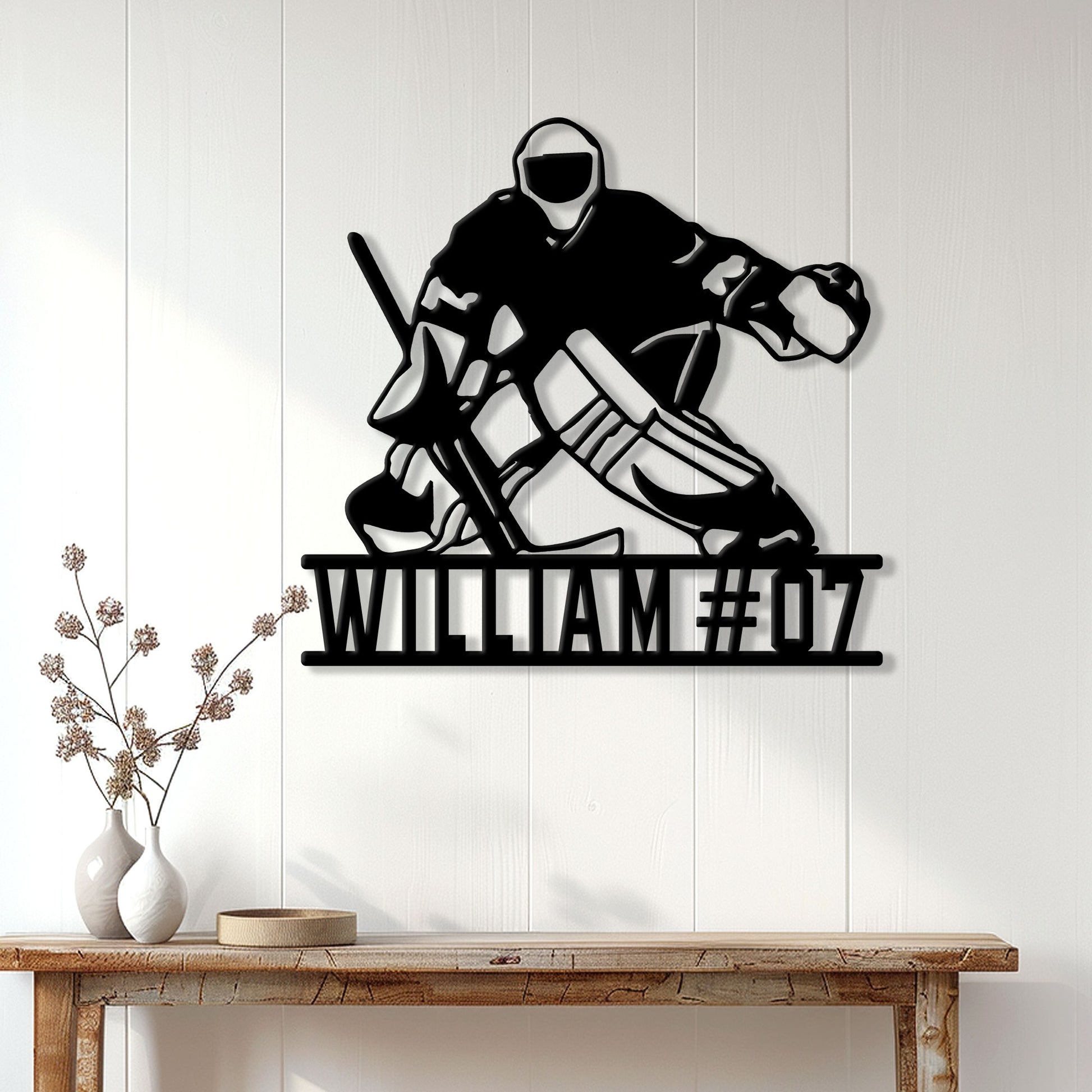Hockey goalie metal wall sign displayed above a console table in a bright home interior