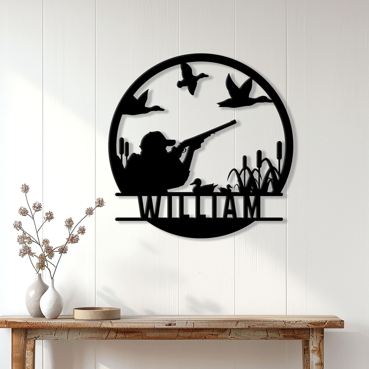 Duck hunting wall decor displayed on a light paneled wall above a rustic console table