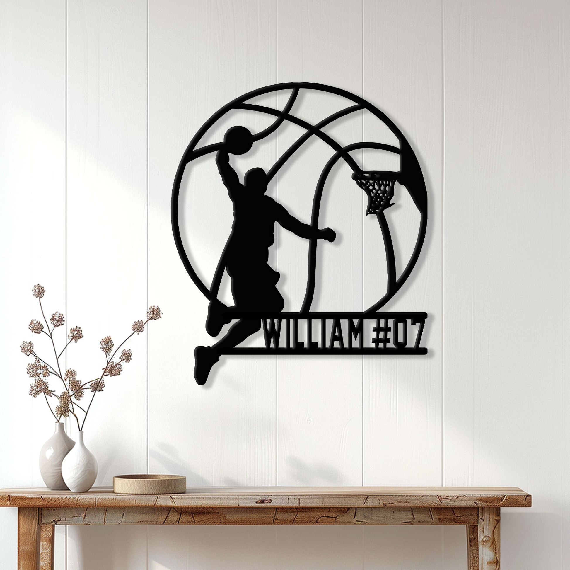 Basketball player silhouette metal wall sign displayed above a console table in a bright home