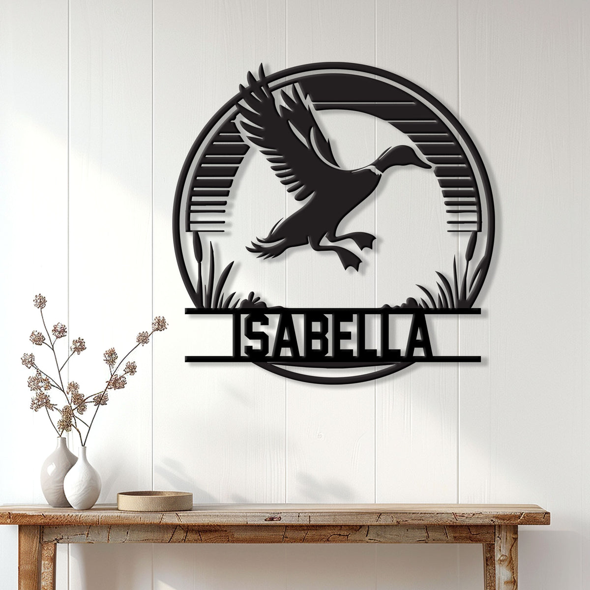 Duck hunting wall decor displayed on a white paneled wall above a console table