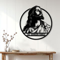 Jesus family metal sign displayed on a light wood-paneled wall above a console table