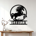 Black horse wall sign displayed on a bright paneled wall above a rustic console table