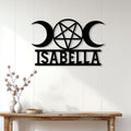 Triple moon and pentagram Wicca wall sign displayed on a light wood-paneled wall above a console table