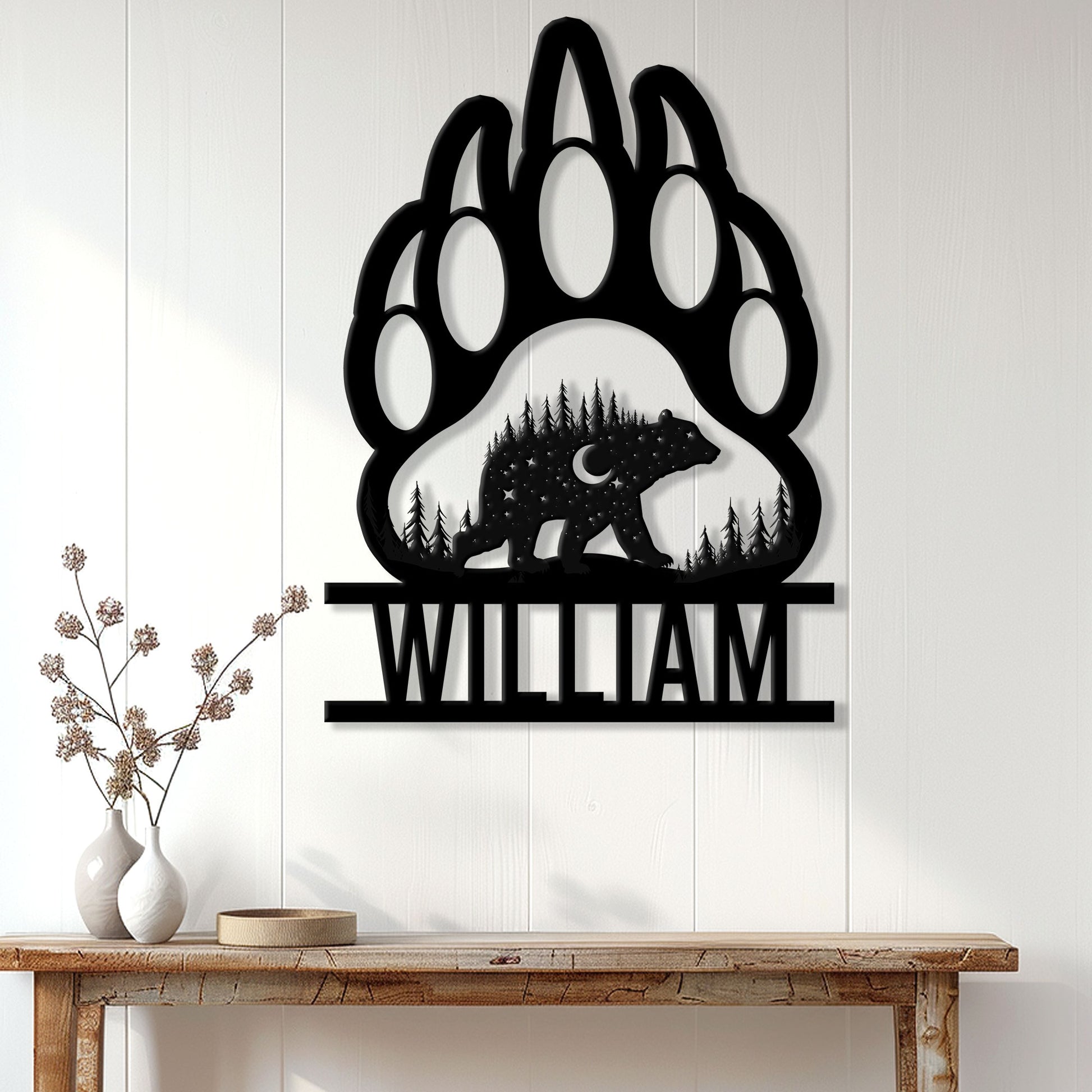 Bear paw metal wall sign displayed on a light paneled wall above a wooden console