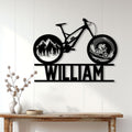 Mountain biking wall decor displayed on a white paneled wall above a wooden console table