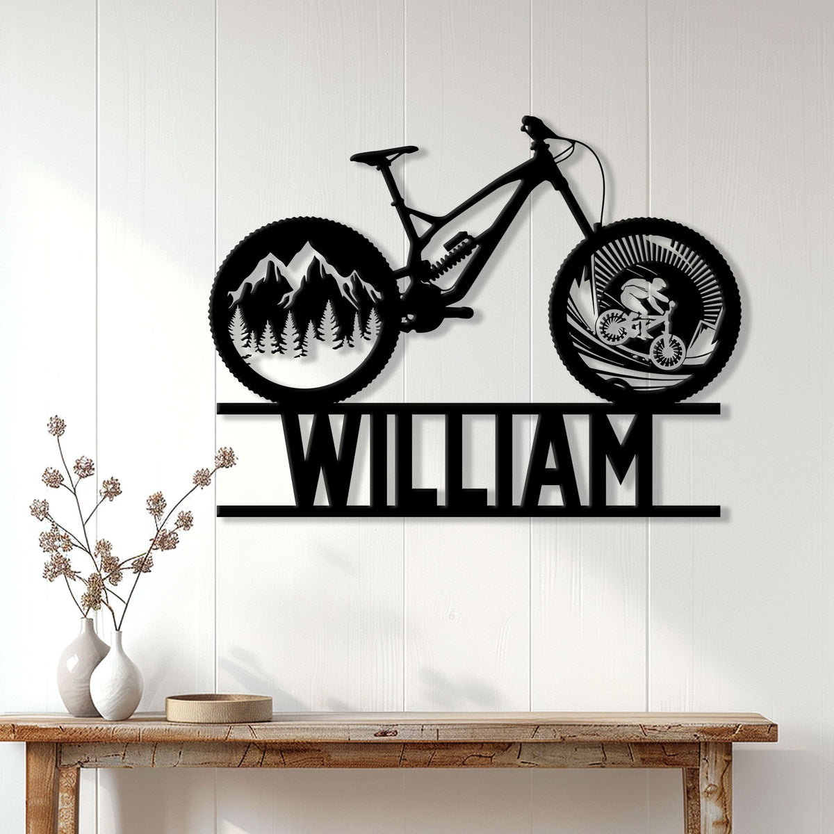 Mountain biking wall decor displayed on a white paneled wall above a wooden console table