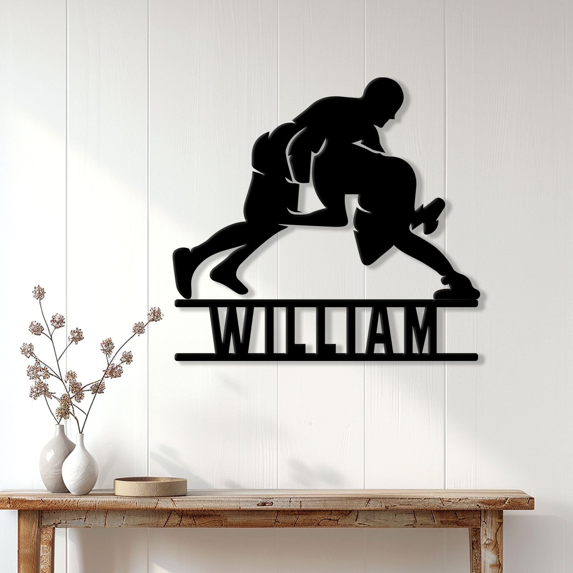 Wrestling wall decor displayed on a white wood wall above a console table