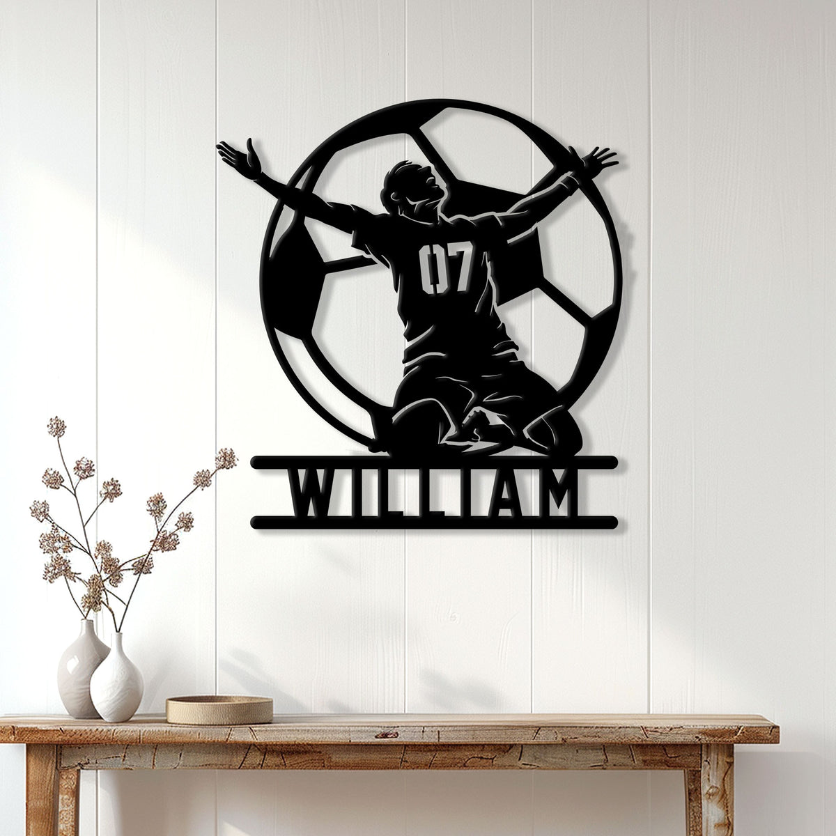 Soccer goalkeeper wall sign displayed on a light wood-paneled wall above a console table